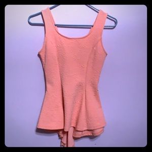 Peach peplum shirt with bow on the back